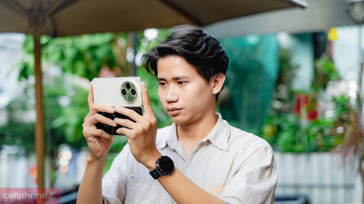 Người dùng đang trải nghiệm OPPO Find N3 phiên bản màu vàng (Gold) ở chế độ mở rộng màn hình, làm nổi bật cụm camera tròn lớn phía sau